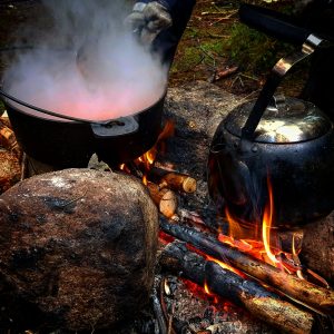 Mat lagas över över öppen eld i en gryta och kokkaffet står på elden