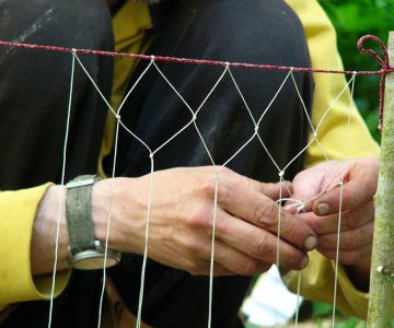 Fraser Christians hands showing how to tie a fishing net